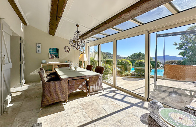 covered terrace with view of the hills, Grimaud castle, and village