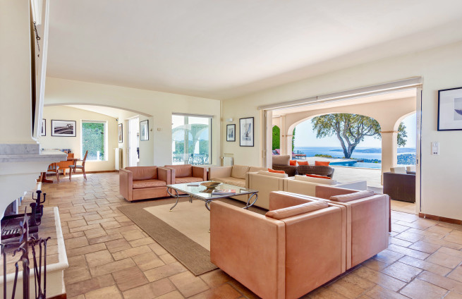living room with fireplace and sea view in Sainte-Maxime