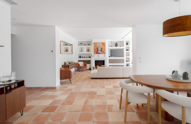 bright living room with fireplace and terrace