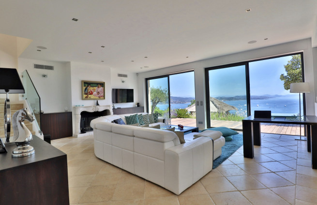 Luxury villa living room with fireplace and sea view in Saint-Tropez